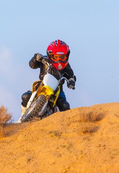 boy racer on a motorcycle in the desert, summer day