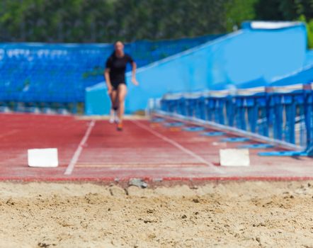 athlete jumps in length, sports background