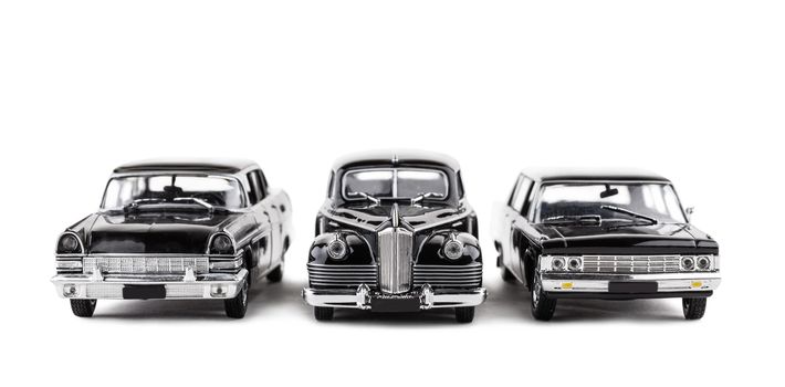 three vintage toy cars isolated on a white background