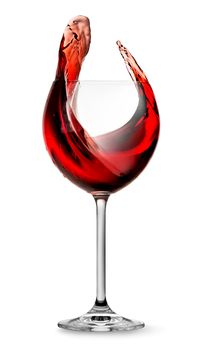 Elegant red wine splashing in wineglass isolated on white