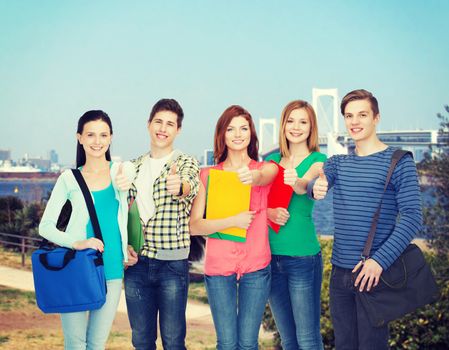 education and people concept - group of smiling students standing