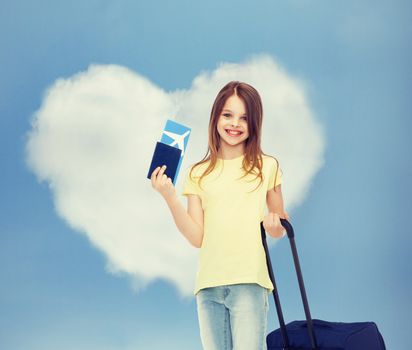 tourism, vacation, childhood and transportation concept - smiling little girl with travel bag, ticket and passport over airport background