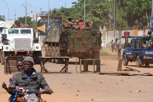 CENTRAL AFRICAN REPUBLIC, Bangui  : Soldiers of the United Nations Multidimensional Stabilization Mission in Central African Republic, Minusca, and french army pass on a street in Bangui, as they patrol in the city, on October 27, 2015,  after protesters attacked and plundered Muslim houses and shops in the aftermath of the murder of at least one clean water delivery man, on October 26. The Central African Republic descended into bloodshed on last September, more than two years ago after long time president Francois Bozize, a Christian, was ousted by Seleka rebels, triggering the worst crisis since independence in 1960. 