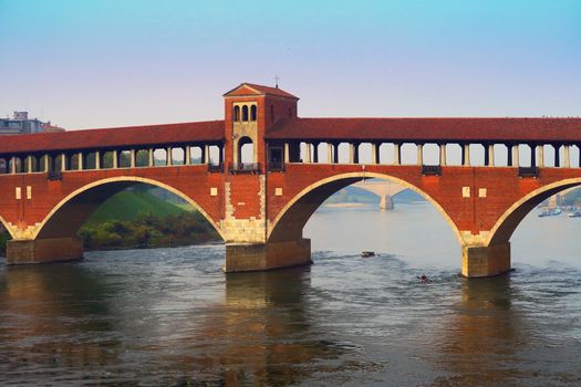 Covered bridge on Ticino river in Pavia, Lombardy. Although the current bridge was built in 1949, it recreates the forms of the ancient covered bridge, dating from the fourteenth century.