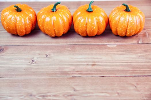 Pumpkin ornaments on desk with copy space