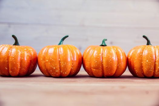 Pumpkin ornaments on desk with copy space