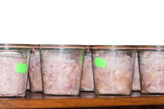 Even slaughtered bright sausage in jar. In a series on the shelves.