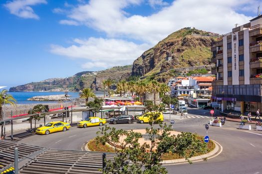 Ribeira Brava, Portugal - June 1, 2013: At the southern end of Ribeira Brava not far from the beach. Roundabout with Taxis, Hotel Bravamar on the right.