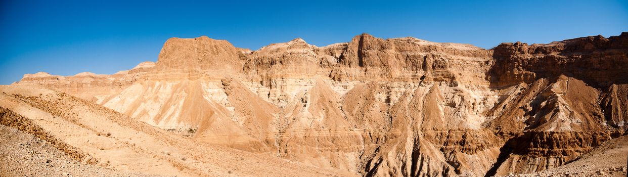 Wide panorama of stone desert mountains in Israel near Dead Sea