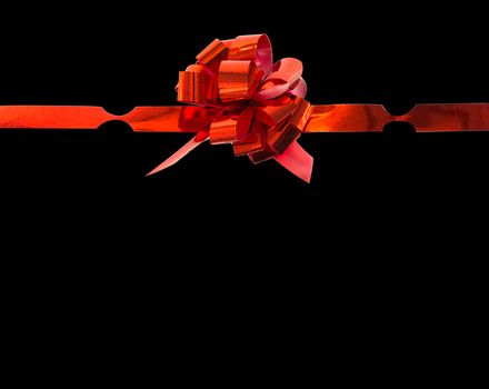 red gift ribbon bow isolated on black