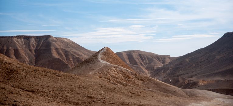 Stone desert tourism hiking in mountains under blue sky