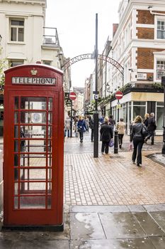 LONDON - APRIL 1: a red phone box in a crowded street on April 1, 2010 in London UK