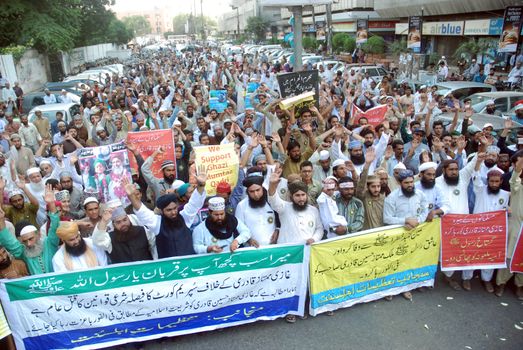 PAKISTAN, Karachi: Islamist supporters of Mumtaz Qadri march through Karachi, Pakistan on October 28, 2015 to speak out against his death sentence. Qadri, a police bodyguard, was convicted of murder after he reportedly shot and killed Punjab Governor Salman Taseer in Islamabad in 2011, due to the governor's support of liberal reforms to Pakistan's blasphemy law.