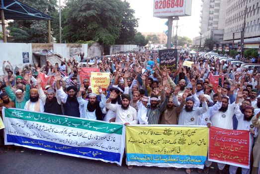 PAKISTAN, Karachi: Islamist supporters of Mumtaz Qadri march through Karachi, Pakistan on October 28, 2015 to speak out against his death sentence. Qadri, a police bodyguard, was convicted of murder after he reportedly shot and killed Punjab Governor Salman Taseer in Islamabad in 2011, due to the governor's support of liberal reforms to Pakistan's blasphemy law.