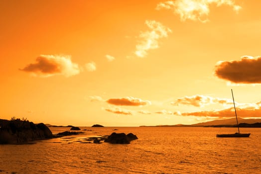 boat in a quiet bay near kenmare on the wild atlantic way ireland at sunset