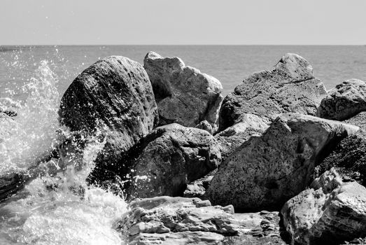 wave crashing on a cliff with foam