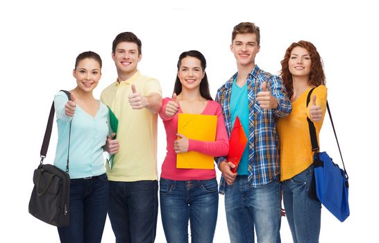 friendship, youth, education and people concept - group of smiling teenagers with folders and school bags showing thumbs up