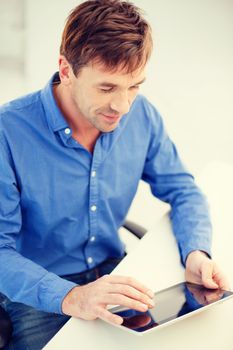 technology and lifestyle, distance learning concept - handsome man working with tablet pc at home