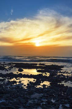 reflections at rocky beal beach near ballybunion on the wild atlantic way ireland with a beautiful yellow sunset