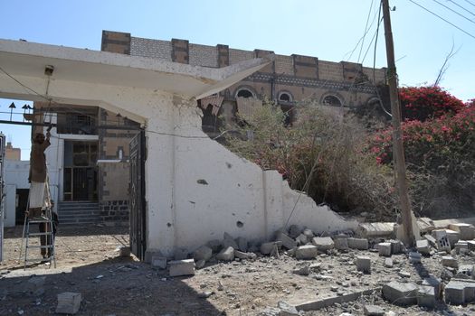 YEMEN, Sanaa: A man stands on a ladder as he surveys a heavily damaged building in Sanaa, Yemen on October 28, 2015, following recent airstrikes by the Saudi-led coalition amid a fierce civil war. According to the contributor, this photo shows the Al Jeraf neighborhood of Sanaa.