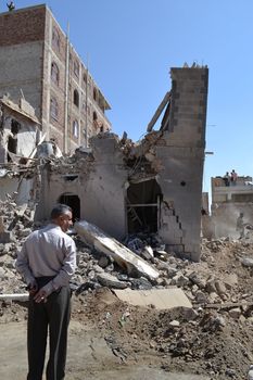 YEMEN, Sanaa: A man surveys the damage in Sanaa, Yemen on October 28, 2015, following recent airstrikes by the Saudi-led coalition amid a fierce civil war. According to the contributor, this photo shows the Al Jeraf neighborhood of Sanaa.