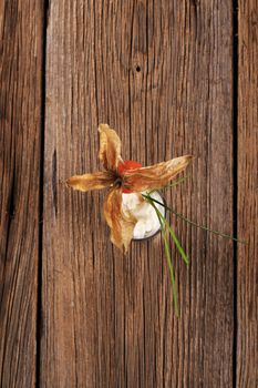 Fresh cheese garnished with physalis fruit and chives