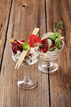 Various cheese appetizers in glass dishes - still life