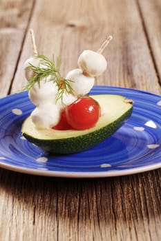 Vegetarian appetizer - Avocado, cherry tomatoes and mozzarella 