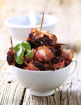 Prunes wrapped  in rashers of bacon - detail