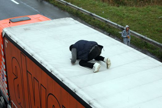 FRANCE, Calais: Migrants from the New Jungle migrant camp in Calais walk along the A16 highway, on October 28, 2015. Around 6.000 migrants live in the new Jungle with the hope of crossing the Channel to Britain.