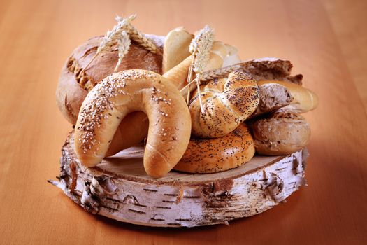 Variety of fresh bread on a piece of wood