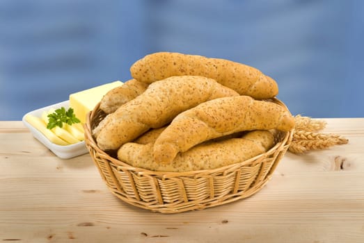 Wholegrain rolls in a basket and fresh butter