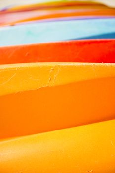 Row of colorful kayaks at sea shore on Tangalooma Island, Queensland.