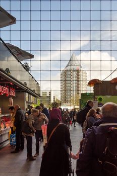 Rotterdam, Netherlands - May 9, 2015: People visit Markthal (Market hall) a new icon in Rotterdam. The covered food market and housing development shaped like a giant arch by Dutch architects MVRDV.