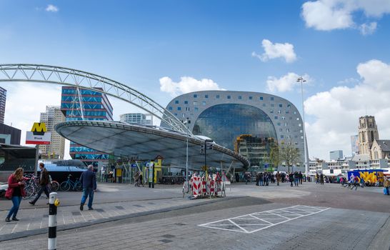 Rotterdam, Netherlands - May 9, 2015: People visit Markthal (Market hall) near blaak station in Rotterdam. The covered food market and housing development shaped like a giant arch by Dutch architects MVRDV.