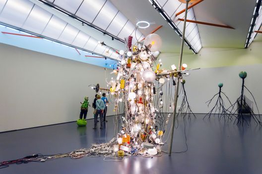 Rotterdam, Netherlands - May 9, 2015: People enjoy exhibition in Kunsthal museum in Museumpark, Rotterdam on May 9, 2015. The building was designed by the Dutch architect Rem Koolhaas.