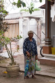 PENIDA ISLAND, INDONESIA - JUNE 29.2015: Wrinkled old Hindu woman at the village Toyapakeh, Nusa Penida, Bali June 29. 2015 Indonesia