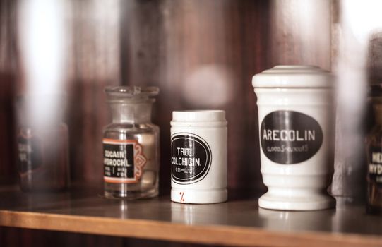 vintage medications in small bottles on a shelf