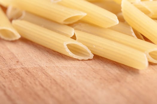 raw the pasta closeup on wooden background 