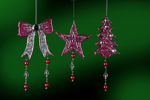 Christmas decorations to hang on the Christmas tree on a  green background