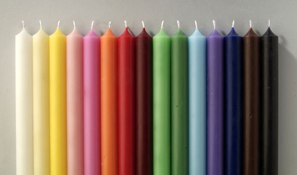 group of colorful cylindrical candles on a white background