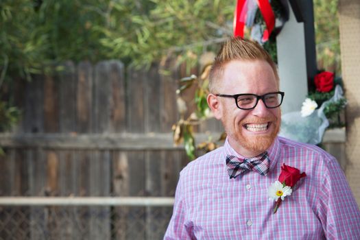 Happy Caucasian man with rose on lapel