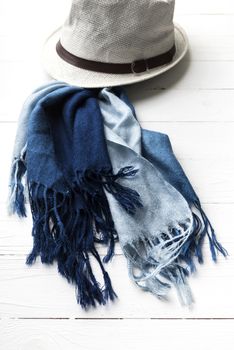 hat and blue scarf on white table
