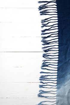 blue scarf over white wood table background