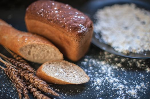 Bread composition with wheats. Very shallow DOF photo and specific art curly bokeh for extra volume.