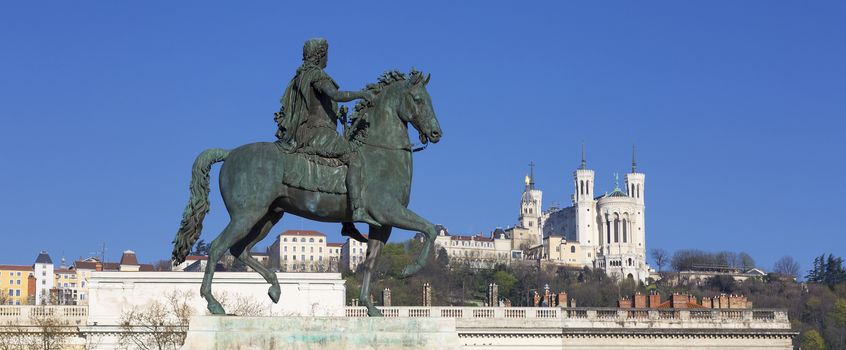 Statue of Louis and Basilique Fourviere on a background, panoramic view.