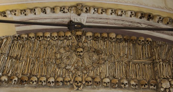 the  Capela dos Ossos  is one of the best known monuments in Évora, Portugal. It is a small interior chapel located next to the entrance of the Church of St. Francis