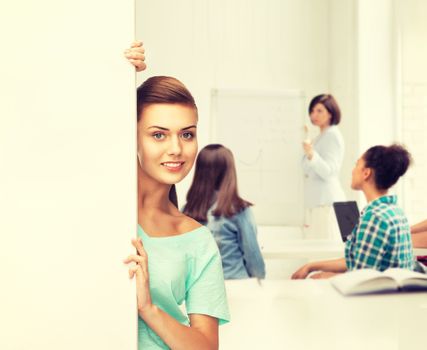 education concept - smiling student girl with white blank board