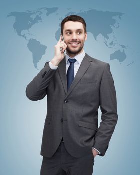 business, technology and education concept - friendly young smiling businessman with smartphone