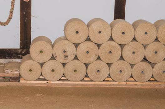 Pile of rope rollers in a textile factory. Use as parcel string.